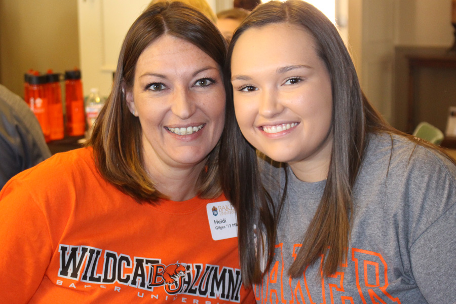 two females smiling at the camera in Baker shirts