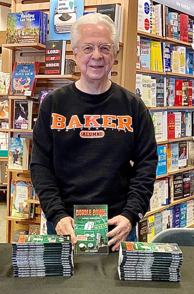 Arthur Nadler standing behind a table with books on it