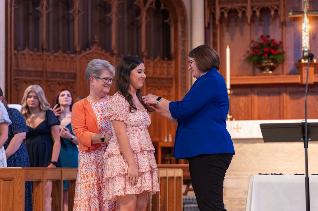 student gets pinned during ceremony