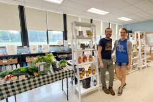 Justine Greve and Robert Riley in front of a display