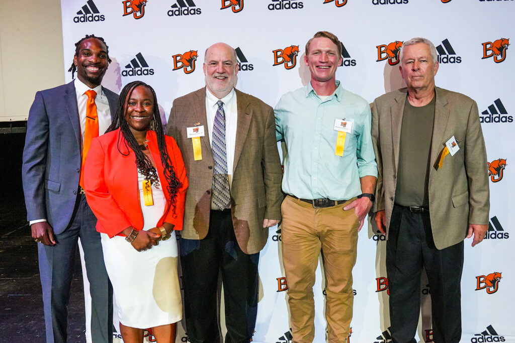 Five of the 2024 inductees in front of a Baker athletics backdrop