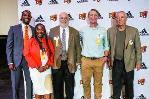 Five of the 2024 inductees in front of a Baker athletics backdrop