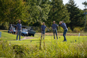 Four male golfers on the course.