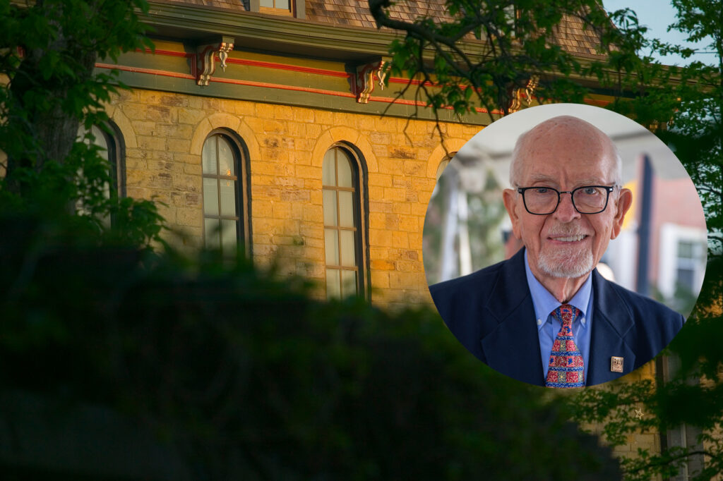 Head shot over photo of Parmenter hall