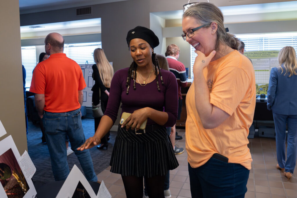 student showing off her work to public