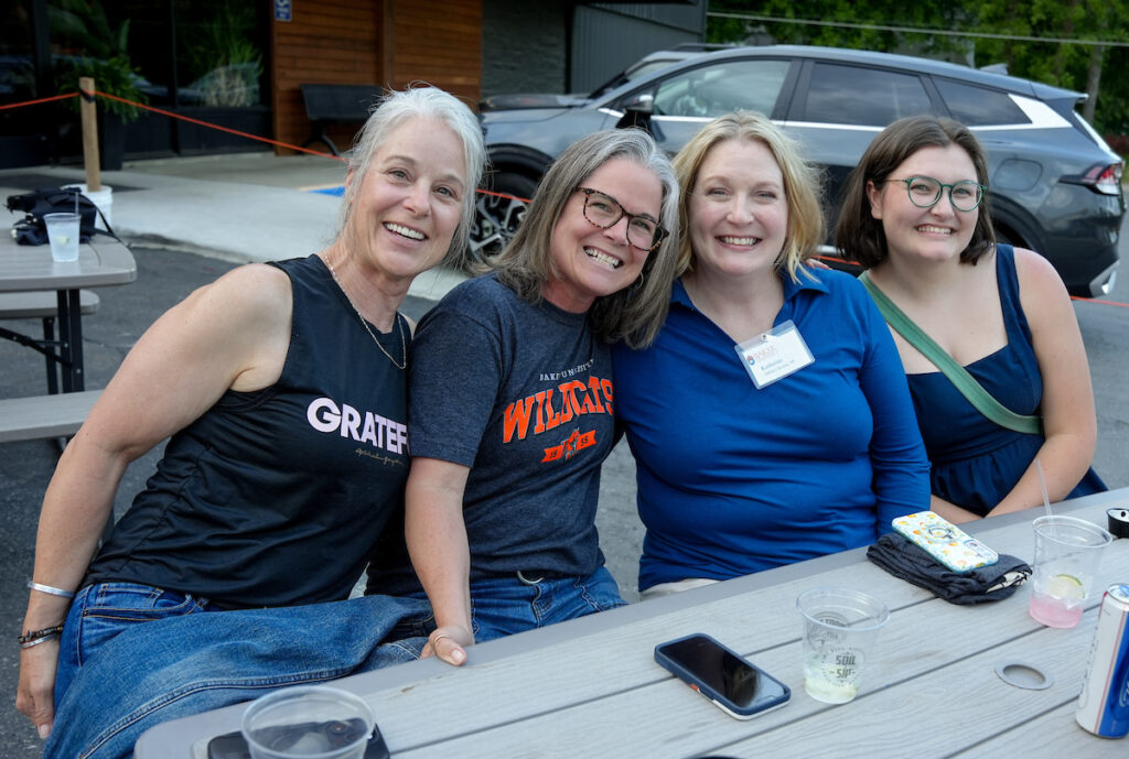 four Baker alums smiling during Alumni Weekend events